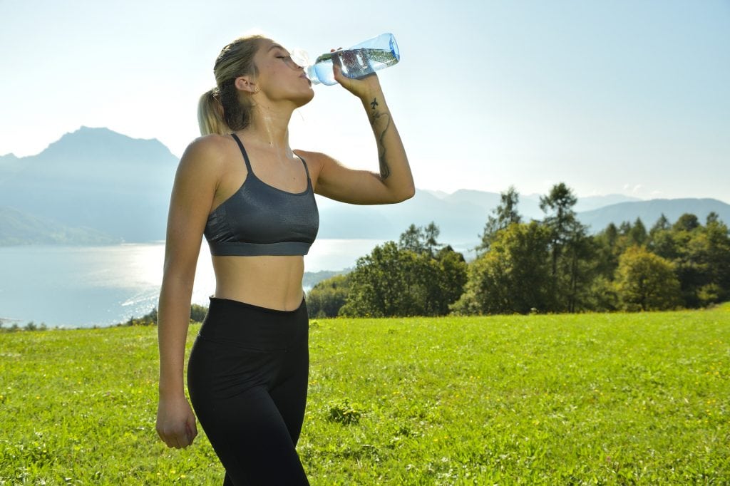 aboutwater drinking bottle: woman drinks water after sport 