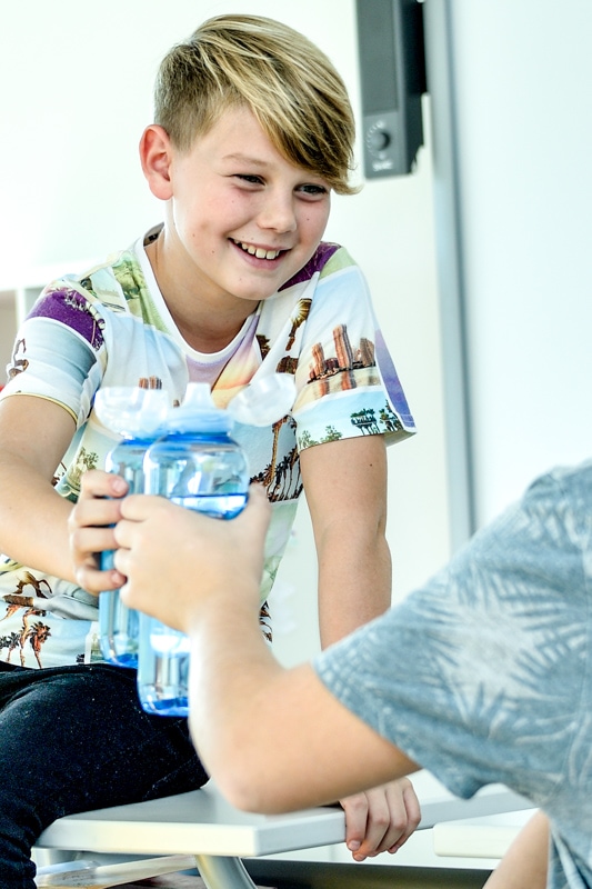 aboutwater water dispenser: child with an innovative drinking bottle for school